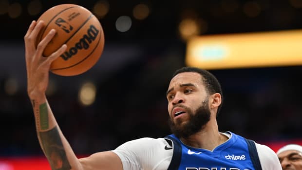 Mavericks center JaVale McGee grabs a rebound.